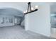 Bright and open living space featuring archways, a staircase, and neutral carpeting at 19058 E Hickock Dr, Parker, CO 80134