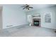 Spacious living room features a stone fireplace, a ceiling fan, and lots of natural light at 19058 E Hickock Dr, Parker, CO 80134
