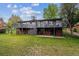 A well-maintained backyard featuring a two-story deck, complemented by lush green grass and mature trees at 2041 W Briarwood Ave, Littleton, CO 80120