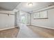 Basement area featuring carpet, white walls, a window letting in natural light, and door with access to the backyard at 2041 W Briarwood Ave, Littleton, CO 80120