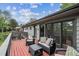 Inviting deck with outdoor seating, red wood flooring, and an attached home exterior with large windows at 2041 W Briarwood Ave, Littleton, CO 80120