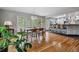 Dining room with hardwood floors, view to kitchen, modern light fixture, and patio doors at 2041 W Briarwood Ave, Littleton, CO 80120
