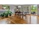 Dining room with modern light fixture, table with chairs, hardwood floors, and lots of light at 2041 W Briarwood Ave, Littleton, CO 80120