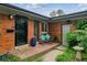 Inviting front porch with brick pavers, bench seating, and a colorful flower arrangement at 2041 W Briarwood Ave, Littleton, CO 80120
