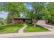 Charming brick home with a well-manicured lawn, mature trees, and attached two car garage at 2041 W Briarwood Ave, Littleton, CO 80120
