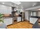 Bright kitchen featuring stainless steel appliances, white cabinets, and plenty of counter space at 2041 W Briarwood Ave, Littleton, CO 80120