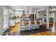 Modern kitchen with white cabinetry, stainless steel appliances, and a breakfast bar with seating at 2041 W Briarwood Ave, Littleton, CO 80120