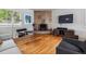 Living room with a stone fireplace, hardwood flooring and a comfortable seating arrangement at 2041 W Briarwood Ave, Littleton, CO 80120