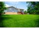 Backyard features expansive green space, mature trees, and a two-story home at 7270 S Cherry Dr, Centennial, CO 80122