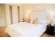 Comfortable bedroom features a soft bed, wood floors, and modern bedside lamps at 7270 S Cherry Dr, Centennial, CO 80122