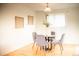 Charming dining area with a glass table, four chairs, and natural light at 7270 S Cherry Dr, Centennial, CO 80122