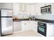 Clean kitchen with white cabinets, tile floors, and stainless steel appliances at 7270 S Cherry Dr, Centennial, CO 80122