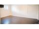 Large room featuring laminate flooring, a window, and ample open space at 7270 S Cherry Dr, Centennial, CO 80122