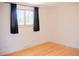 Empty room with light hardwood floors and a bright window at 7270 S Cherry Dr, Centennial, CO 80122