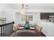 Bright dining room featuring a spacious table and modern light fixture at 8199 Welby Rd # 2304, Denver, CO 80229