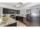 Modern kitchen with stainless steel appliances and granite countertops at 8199 Welby Rd # 2304, Denver, CO 80229