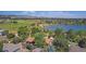 Gorgeous aerial view featuring a lake, mountains, and a mixture of green space and residential properties at 14890 W 58Th Pl, Golden, CO 80403