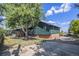 Exterior view of a large home with a spacious yard and a charming deck at 14890 W 58Th Pl, Golden, CO 80403