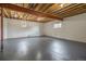 Unfinished basement with exposed ceiling, bright lighting, and two windows at 14890 W 58Th Pl, Golden, CO 80403