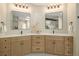 Bright bathroom featuring double vanity with wood cabinets, modern fixtures and quartz countertop at 14890 W 58Th Pl, Golden, CO 80403