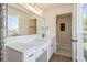 Well-lit bathroom with modern fixtures, stone wall, and direct access to a glass shower at 14890 W 58Th Pl, Golden, CO 80403