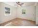 Bright bedroom featuring hardwood floors, two large windows, and a ceiling fan at 14890 W 58Th Pl, Golden, CO 80403