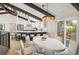 Open-concept dining area with access to kitchen and outside deck perfect for entertaining and everyday living at 14890 W 58Th Pl, Golden, CO 80403