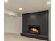 Modern painted brick fireplace with gas insert offers a comfortable basement gathering place at 14890 W 58Th Pl, Golden, CO 80403