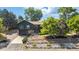 Charming exterior with a landscaped front yard and a combination of stone and dark siding at 14890 W 58Th Pl, Golden, CO 80403
