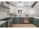Bright kitchen with stainless steel appliances, two-tone cabinets, and a skylight at 14890 W 58Th Pl, Golden, CO 80403