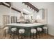 Modern kitchen featuring sleek countertops, stainless steel appliances, ample storage, and breakfast bar seating at 14890 W 58Th Pl, Golden, CO 80403