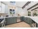 Open kitchen with stainless appliances, two-tone cabinets, and hardwood flooring at 14890 W 58Th Pl, Golden, CO 80403