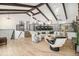 Bright open-concept living room with vaulted ceilings, wooden beams, and access to kitchen at 14890 W 58Th Pl, Golden, CO 80403