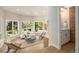 Well-lit living room featuring large windows, sleek furniture, and hardwood floors at 14890 W 58Th Pl, Golden, CO 80403
