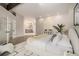 Spacious primary bedroom featuring an ensuite bathroom and modern decor at 14890 W 58Th Pl, Golden, CO 80403
