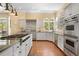 Kitchen featuring stainless steel appliances, granite countertops, hardwood floors and abundant natural light at 17165 Colonial Park Dr, Monument, CO 80132