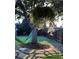 Backyard with a hammock hanging from a tree and a flower garden at 373 S Locust St, Denver, CO 80224