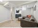 Finished basement with light wood floors, a comfortable couch and a modern entertainment area at 373 S Locust St, Denver, CO 80224