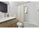 Bright bathroom with white subway tile, modern vanity, and bathtub with shower at 373 S Locust St, Denver, CO 80224
