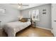 Serene bedroom with hardwood floors, ceiling fan and a comfortable queen-sized bed at 373 S Locust St, Denver, CO 80224