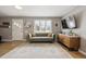 Comfortable living room featuring natural light, a decorative rug, stylish furniture, and hardwood floors at 373 S Locust St, Denver, CO 80224