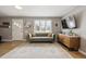 Bright living room with hardwood floors, a modern sofa, and large windows at 373 S Locust St, Denver, CO 80224