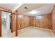 Finished basement featuring classic wood paneling and access to additional spaces at 200 Perry St, Denver, CO 80219
