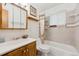 Bathroom featuring a tiled shower, vanity with mirror, and neutral decor at 200 Perry St, Denver, CO 80219