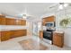 Spacious kitchen with stainless steel appliances, tile floors, and wood cabinets, perfect for cooking at 200 Perry St, Denver, CO 80219