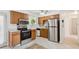 Well-lit kitchen with stainless steel appliances, tile flooring, and classic wood cabinetry at 200 Perry St, Denver, CO 80219