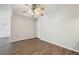A cozy room is highlighted by hardwood floors, neutral paint, and a ceiling fan at 12115 Bannock St # B, Denver, CO 80234