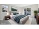 Bright main bedroom with modern decor, a plush rug, and sliding glass doors to a private balcony at 12115 Bannock St # B, Denver, CO 80234