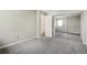 Neutral-toned room with a large mirrored closet, a window, carpeted floors, and a white door at 12115 Bannock St # B, Denver, CO 80234