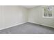 An empty room with neutral colored walls and carpet, and a window at 12115 Bannock St # B, Denver, CO 80234